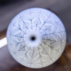 Rhian Malin decorating a mandala bottle in her workshop 2019